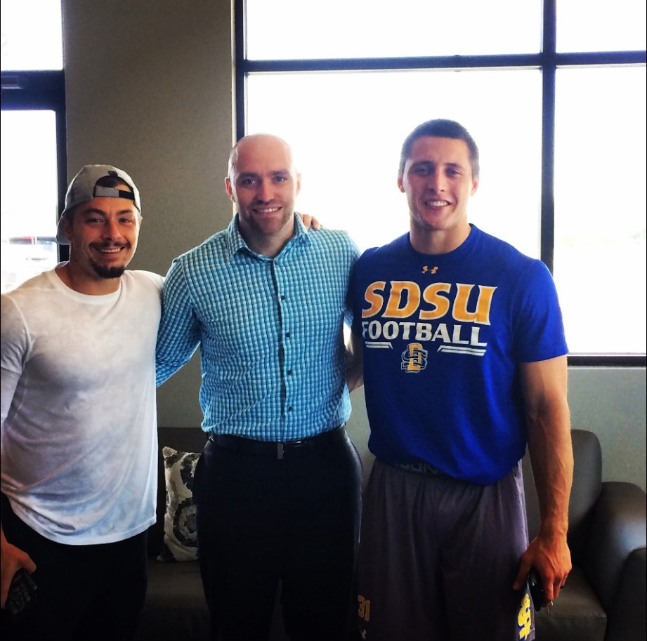 Dr. Dane Becker with NFL running backs Danny Woodhead and Zach Zenner at Becker Chiropractic in West Omaha
